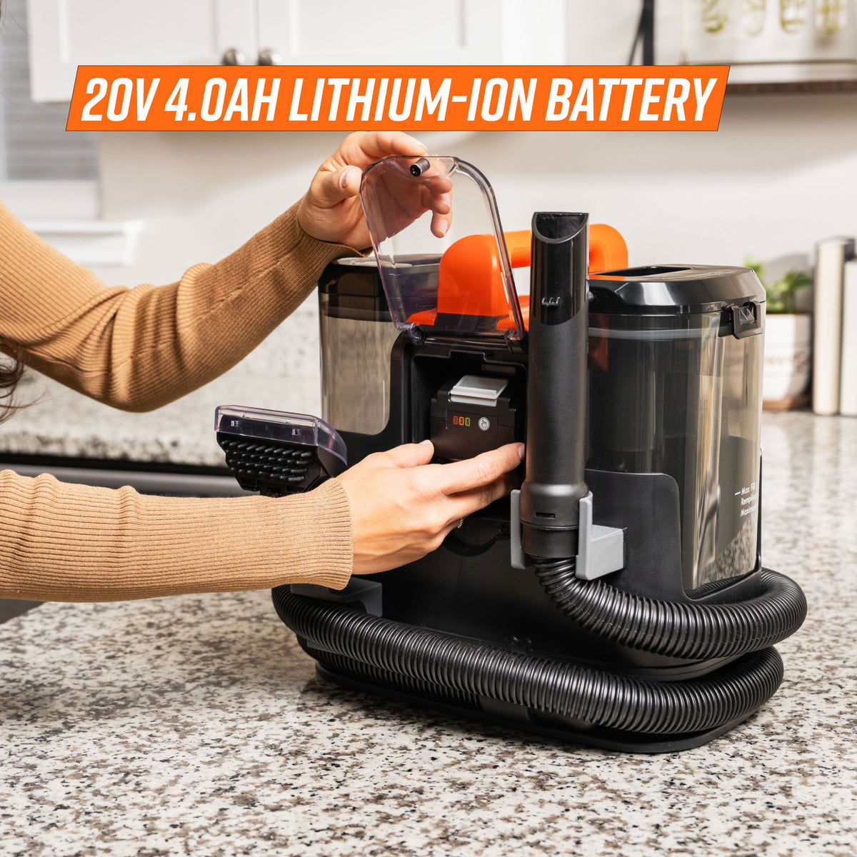 A person places a 20V 4.0Ah lithium-ion battery into a spot cleaner