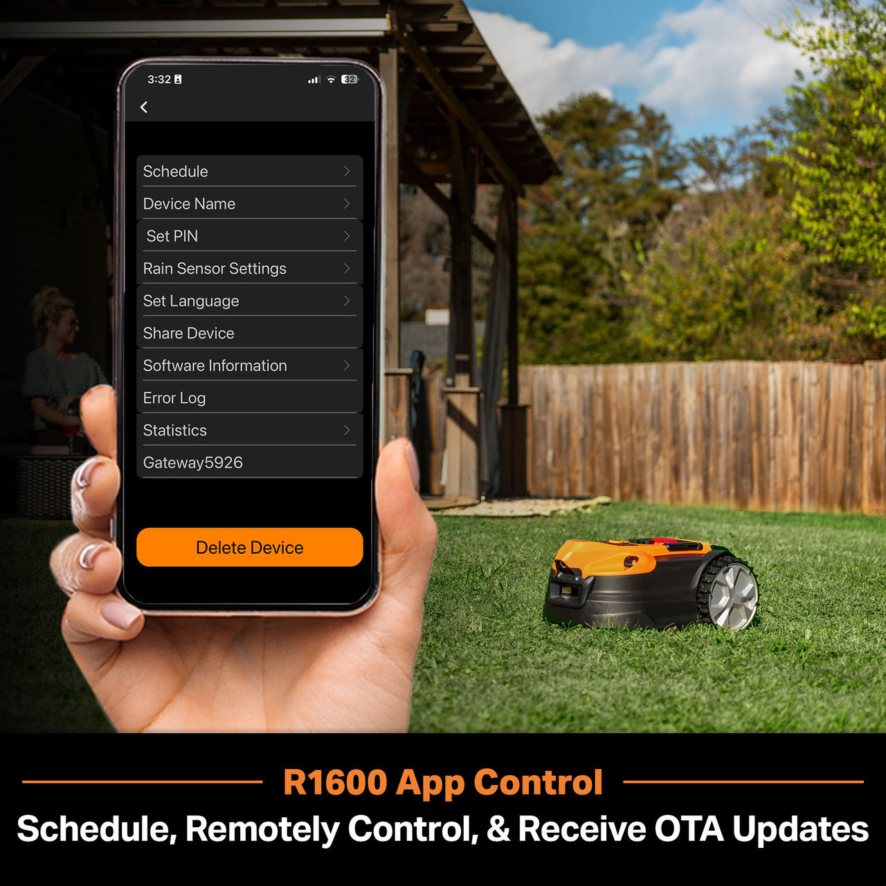 Hand holding a smartphone with app control for a robot lawn mower in a backyard setting.