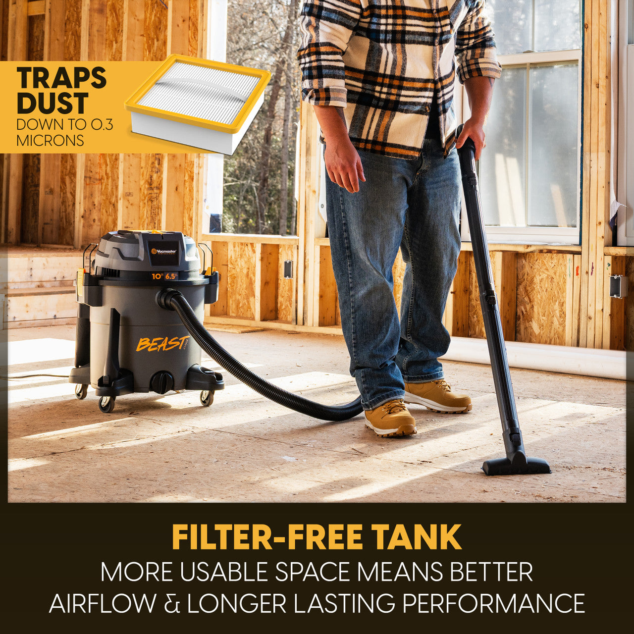 A person uses the vacuum to clean up at a construction site. Filter-free tank is highlighted.